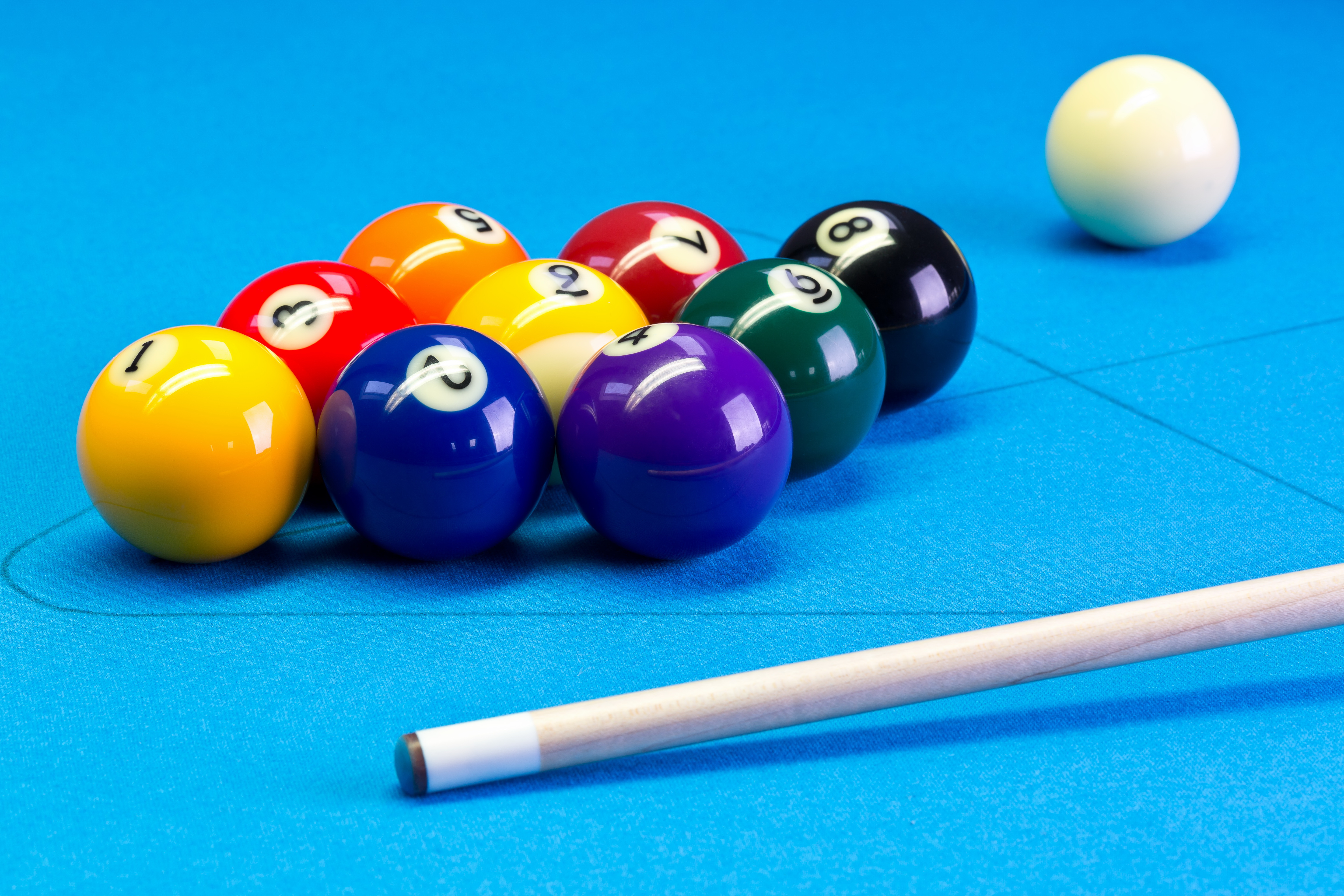 Billiard pool game nine ball with nineball balls set up with cue on billiard table with blue cloth